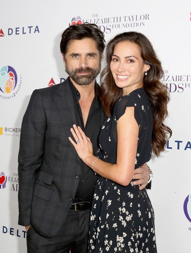 BEVERLY HILLS, CA - OCTOBER 24:  (EDITORIAL USE ONLY. NO COMMERCIAL USE)  John Stamos (L) and Caitlin McHugh attend The Elizabeth Taylor AIDS Foundation and mothers2mothers dinner at Ron Burkle's Green Acres Estate on October 24, 2017 in Beverly Hills, California.  (Photo by Rachel Murray/Getty Images for mothers2mothers and The Elizabeth Taylor AIDS Foundation ) mothers2mothers And The Elizabeth Taylor AIDS Foundation Benefit Dinner At Ron Burkle's Green Acres Estate 2017 Getty Images 775051810 98142498 Getty Images North America Stringer 